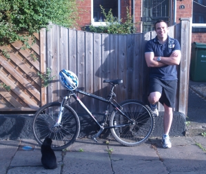Keith with arms folded standing next to his bike